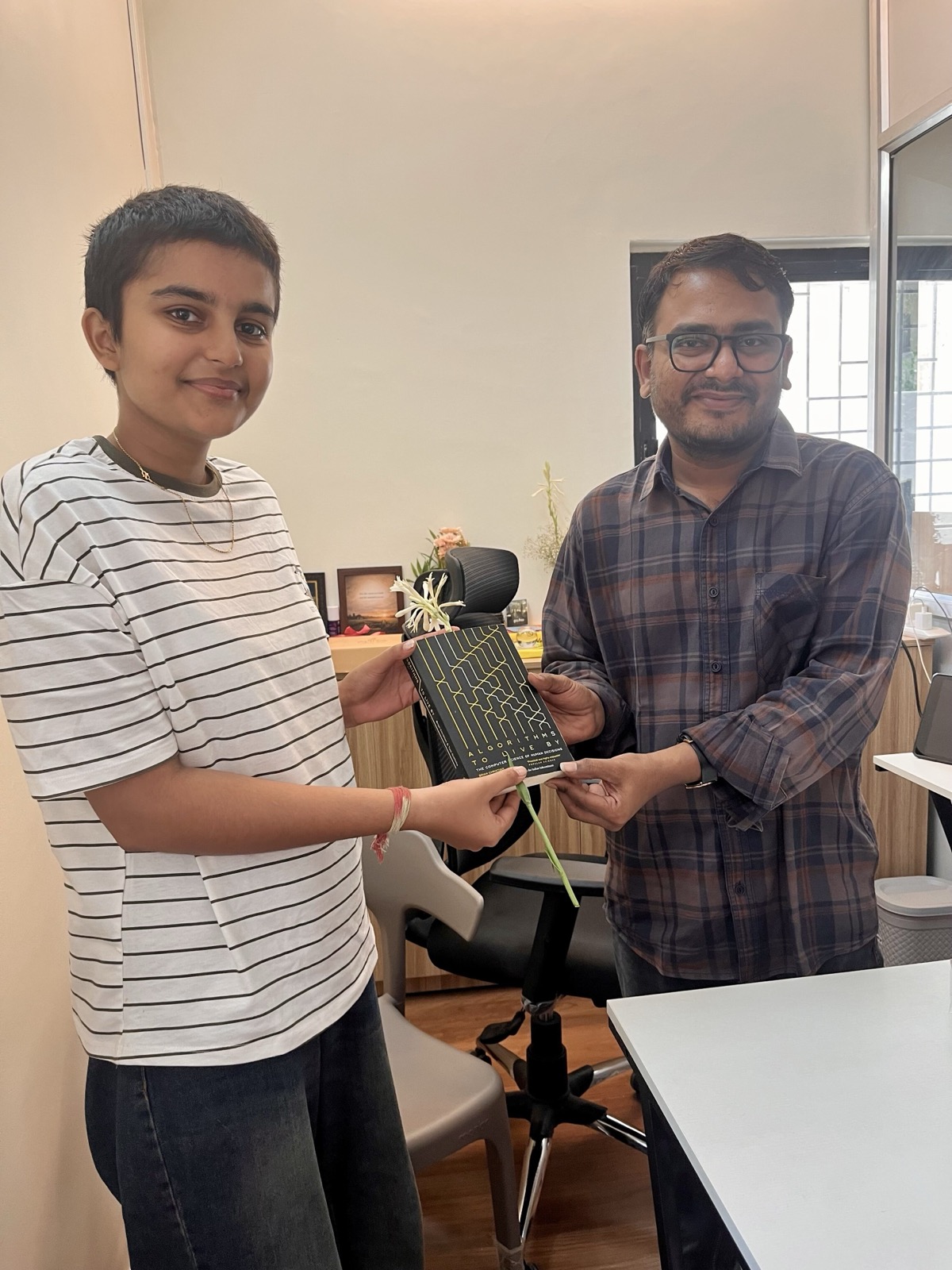 Anuja Gurav receiving a book at Chatake Innoworks